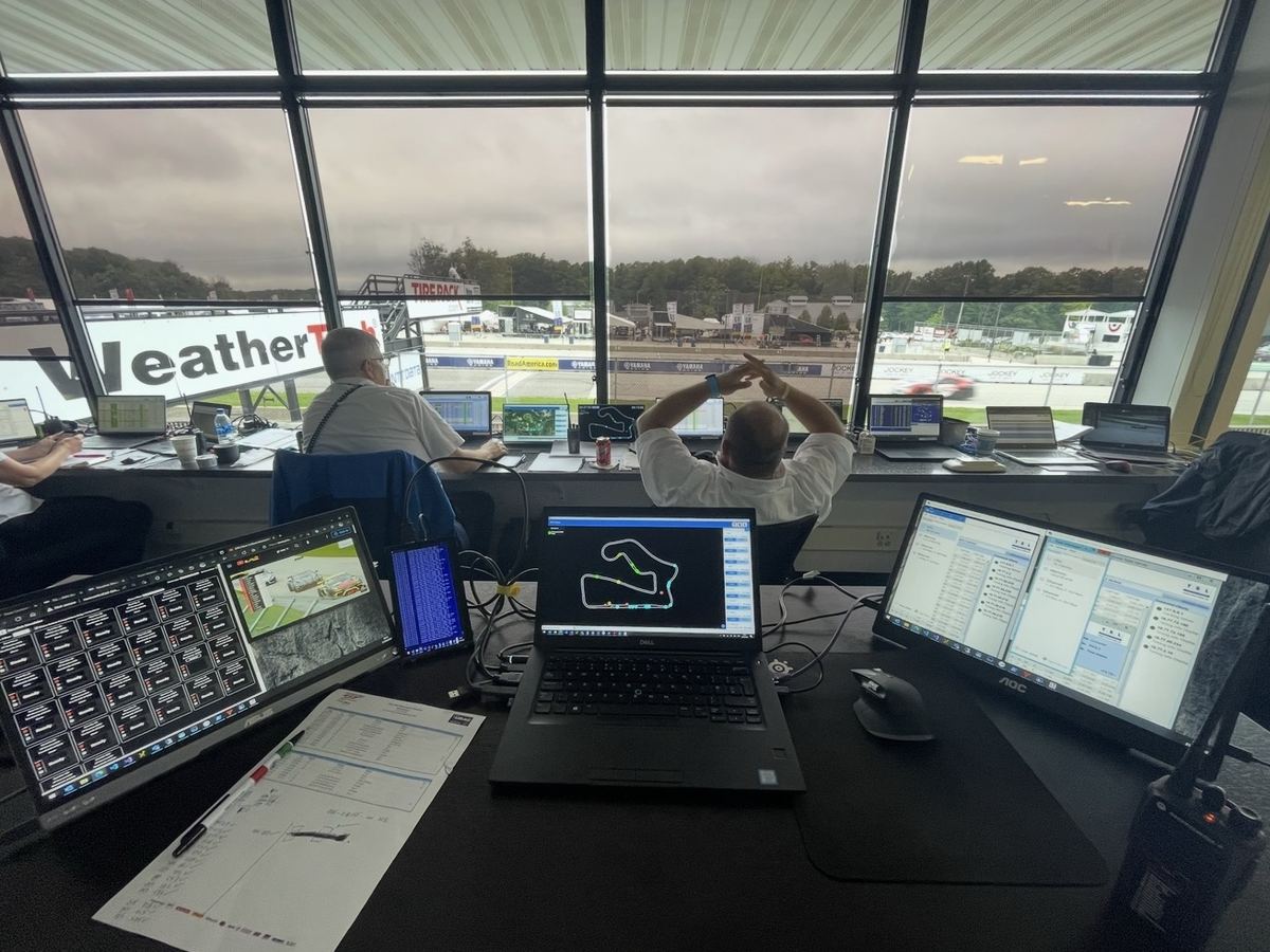 The timing room at Road America during a session, with screens facing the track